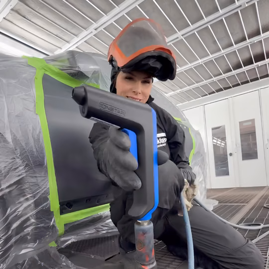 Refinisher using IONSTAR beside a masked vehicle body